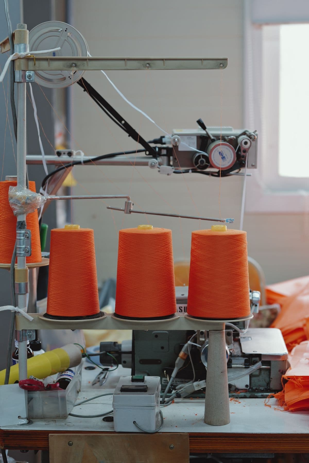 Cones of yarn feeding a knitting machine